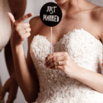 Bride and her bridesmaid holding accessories for the wedding photo shoot. Wedding concept.