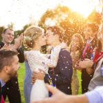 Newlyweds with guest on their garden party